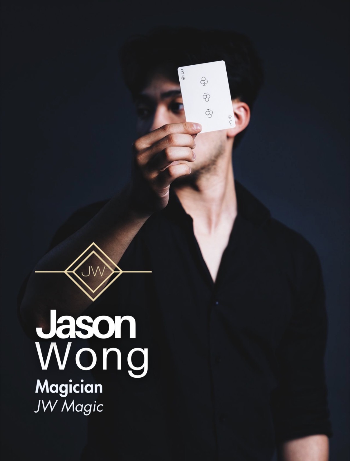 Jason Wong, magician, holding up the three of clubs
